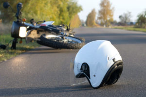 Motorcycle Accident Lawyer Charlotte, NC- Motorcycle fallen over with helmet in the road