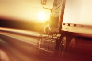 Truck Accident Lawyer Charlotte, NC - Semi Truck In Motion. Speeding Truck on the Highway. Trucking Business Concept